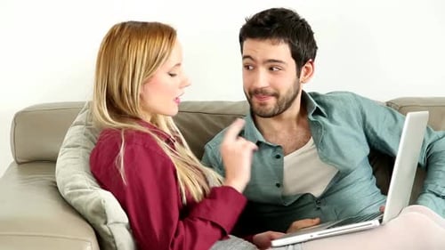 Couple Using Laptop Together on Sofa