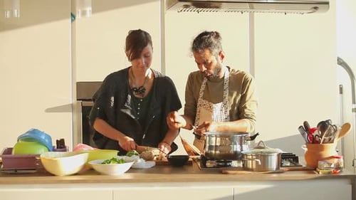Woman and Man Cooking Together in Bright Kitchen