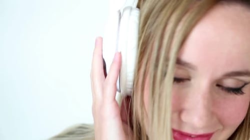 Close Up Of Beautiful Young Blond Woman Dancing With White Headphones 12