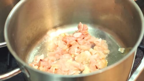 Raw Chicken Being Cooked in a Steel Pot