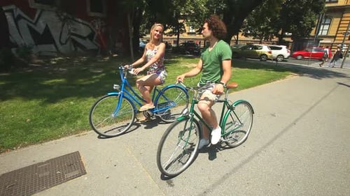 Couple Enjoying Bicycle Ride in Urban Environment