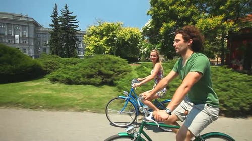 Happy Couple Biking Together on Sunny Day