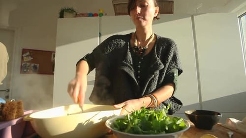 Woman Preparing Food in a Bright Kitchen
