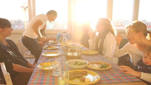 Friends and Family Enjoying Meal at Sunset