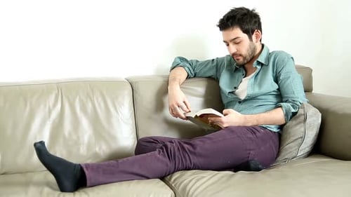 Man Relaxing at Home, Reading a Book