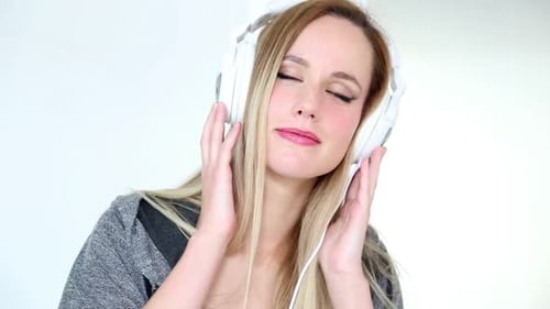 Young Woman Listening Music with Headphones