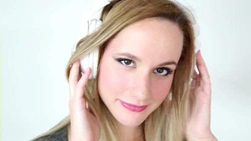 Woman with Headphones Listening to Music Close Up