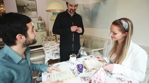 Couple and Waiter Discussing Menu at Restaurant