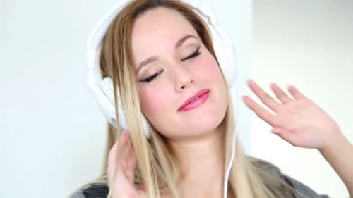 Woman Listens to Music with Headphones