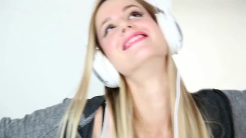 Woman Enjoying Music With White Headphones On
