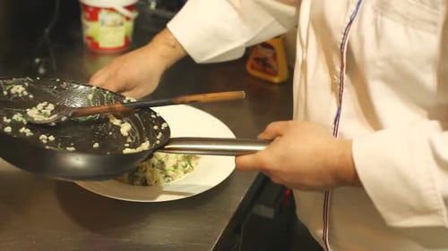 Chef Plates Steaming Gourmet Dish in Restaurant Kitchen