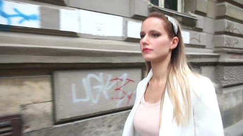 Beautiful Young Woman Walking Down The Street