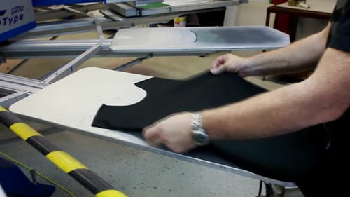 Black Clothing Placed on Printing Press