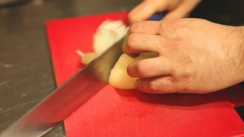 Chef Slicing Fresh Onion with Sharp Knife
