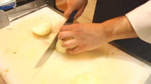 Chef Dicing an Onion on Cutting Board
