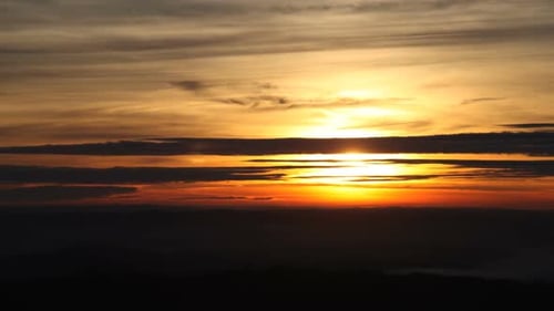 Brilliant Sunrise or Sunset Over Silhouetted Landscape