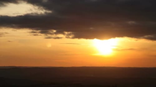 Fiery Sunset Over a Mountainous Landscape