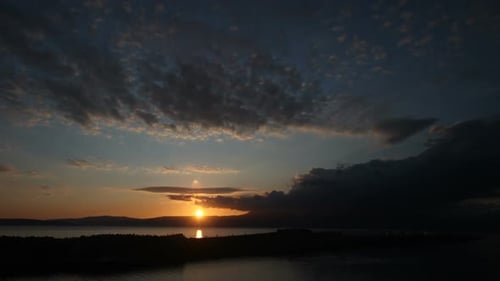 Coastal Sunset with Dramatic Clouds Over Ocean