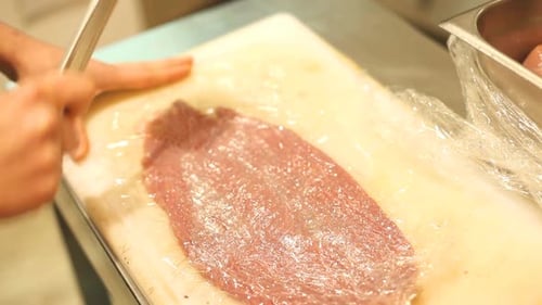 Chef Prepares Meat on a Cutting Board