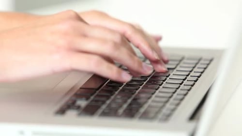 Hands Typing on Laptop Keyboard, Close Up