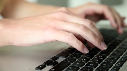 Hands Typing on a Laptop Keyboard Close Up
