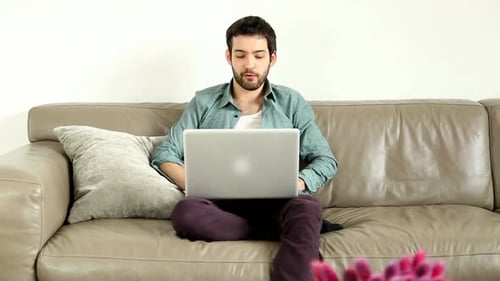 Young Adult Working on Laptop at Home