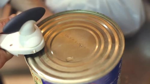 Close Up of Can Opener Opening Tomatoes