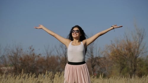 Woman With Arms Outstretched In a Wheat Field