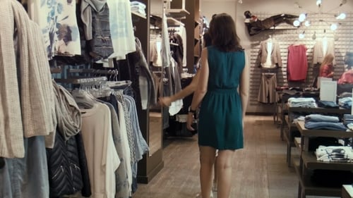 Two Young Girls Choose Clothes In Shop