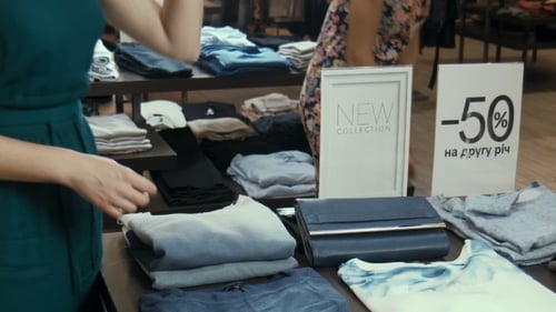 Women Browse New Fashion Collection in Retail Store
