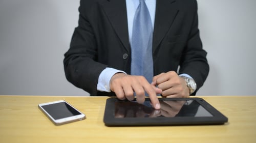 Well Dressed Man Working on Digital Tablet