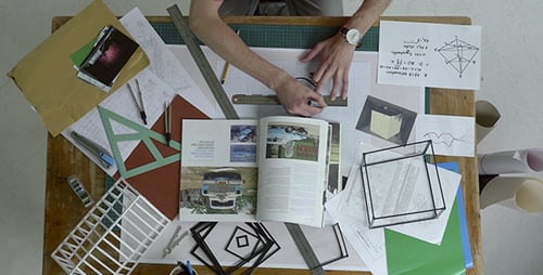 Architect at Drafting Table Drawing Plans