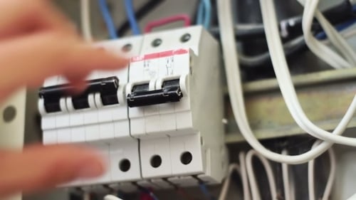 Hand Operating Electrical Breakers Close Up