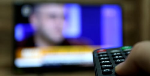 Hand Using Remote to Change Television Channels