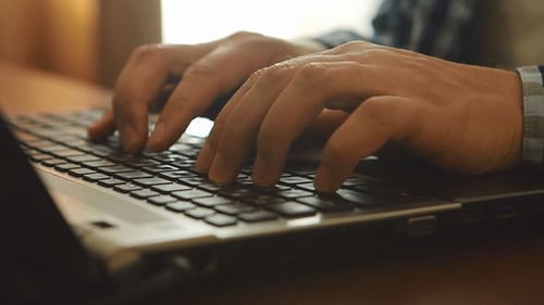 Hands Typing On A Notebook