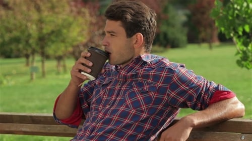 Male On Park Bench With Coffee