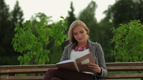 Girl Student Sitting On a Park Bench