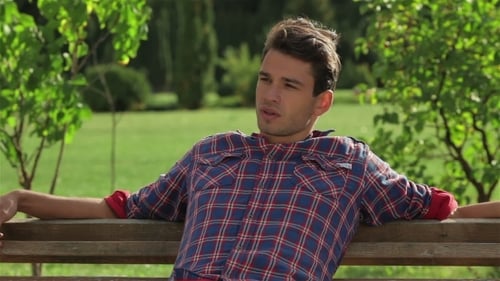 Young Man Relaxing on a Park Bench