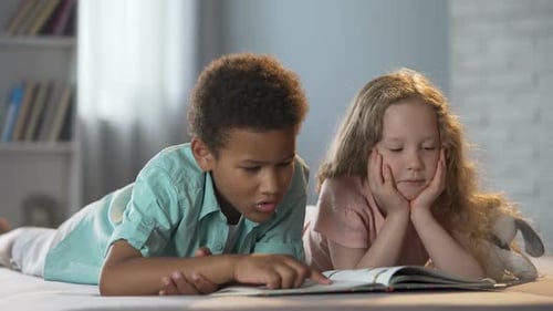 Little Girl Watching as Her Afro-American Friend Learning to Read by Syllables
