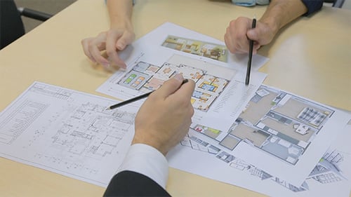 Real Estate Broker Shows Plan of Apartment