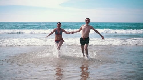 Happy Couple Having Fun On Ocean Waves
