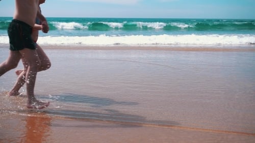 Happy Couple Running On Beach