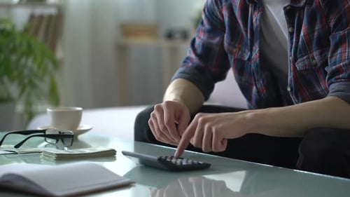 Man Calculating Income and Expenses, Deferring Money for Travelling, Weekends