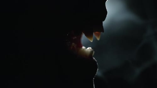 Sinister Monster Silhouette with Razor-Sharp Teeth