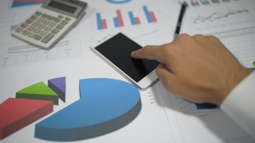 Financier Using Smartphone in Office