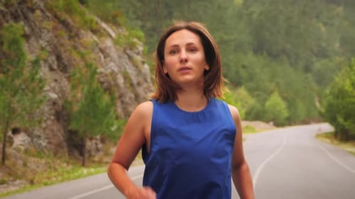 Woman Running on Rural Road for Health and Fitness