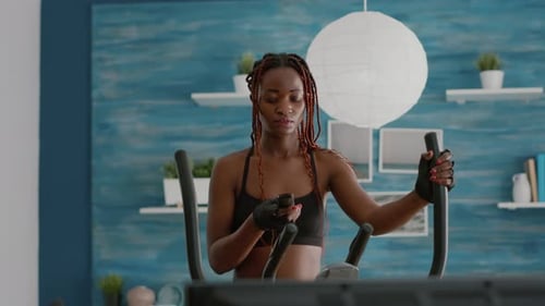 Woman Using Exercise Bike in Her Home Gym