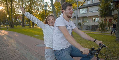 Cheerful Couple Biking Together in the Park