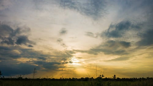 Dramatic Golden Sunset Over Rural Landscape