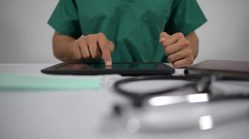 Doctor Busy Using Tablet